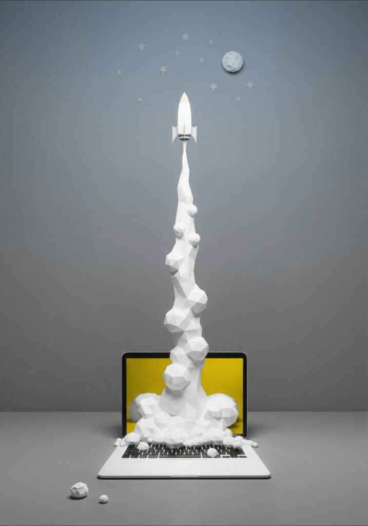 A 3D render of a rocket coming out of a laptop